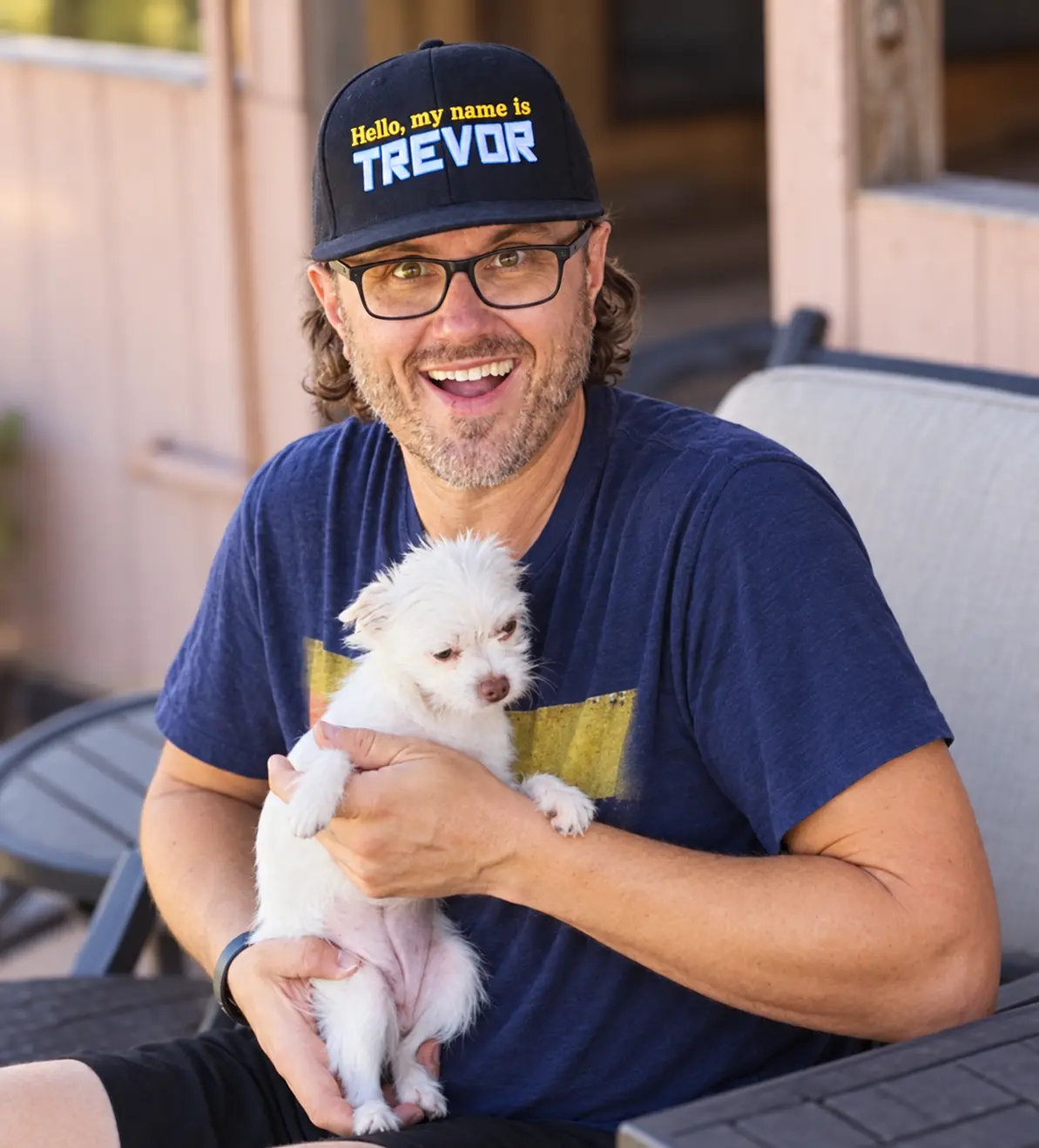 Trevor Chevalier smiling while holding one of his dogs